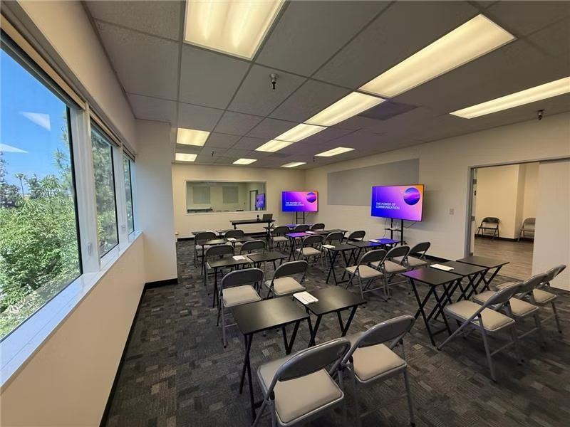 Suite A set up in a classroom layout with rows of desks facing screens